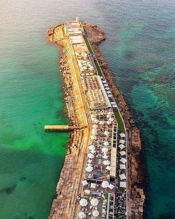 Aerial view of a coastal breakwater and waterfront development